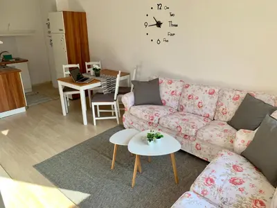 a living room with a couch and a table at Premium Apartments Bansko in Bansko
