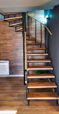 a set of stairs in a room with wooden walls at Къща за гости “Приятели“ in Ovchartsi