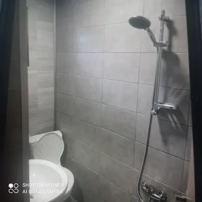 a bathroom with a toilet and a shower at Къща за гости “Приятели“ in Ovchartsi