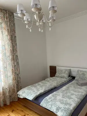 a bedroom with two beds and a chandelier at Parchevich 26 Apartment - 24h Self Check-in in Sofia