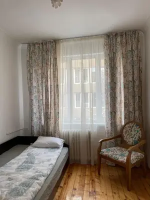 a bedroom with a bed and a chair and a window at Parchevich 26 Apartment - 24h Self Check-in in Sofia