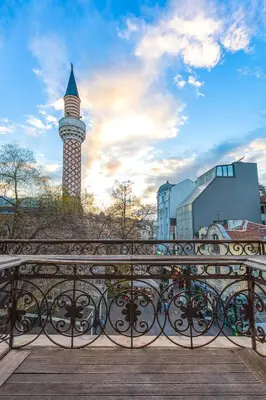 a bridge with a fence with a tower in the background at 1BD Apartment with a Cute Balcony in Kapana by Flat Mаnager in Plovdiv