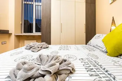 a bedroom with a bed with a blanket on it at 1BD Apartment with a Cute Balcony in Kapana by Flat Mаnager in Plovdiv