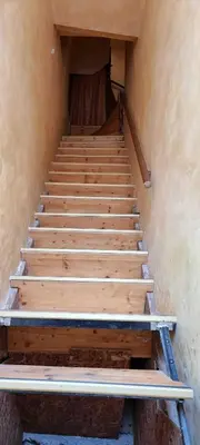 a set of wooden stairs in a building at 1BD Apartment with a Cute Balcony in Kapana by Flat Mаnager in Plovdiv