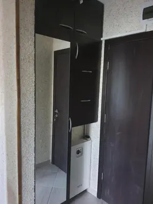 a bathroom with a mirror and a door in a room at Green Life, Bansko, private property in the complex Paradiso Verde, apartman C23 in Bansko