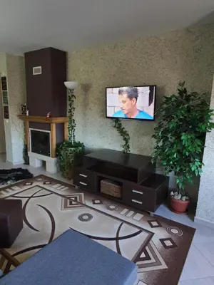 a living room with a flat screen tv on the wall at Green Life, Bansko, private property in the complex Paradiso Verde, apartman C23 in Bansko