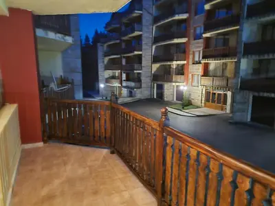 a balcony with a wooden railing and some buildings at Borovets Sequoia2 Apartment no 5 in Borovets