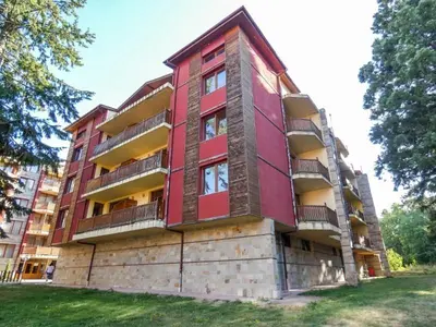 a red building with balconies on the side of it at Borovets Sequoia2 Apartment no 5 in Borovets
