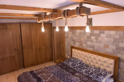 a bedroom with a bed and a brick wall at Лукс апартамент in Bansko