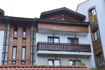 a building with a balcony on the side of it at Лукс апартамент in Bansko