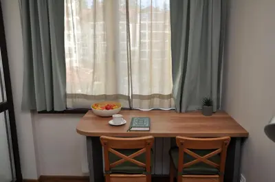 a table with two chairs and a bowl of fruit on it at Hashtag Studio Borovets in Borovets