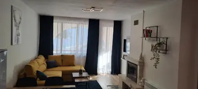 a living room with a couch and a window at Apartments KaVi , Monastery 1 & 3, Grand Monastery,Pamporovo in Pamporovo