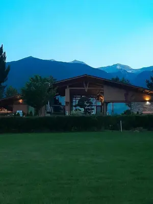 a house with a green lawn in front of it at Vintage studio at Pirin golf in Bansko