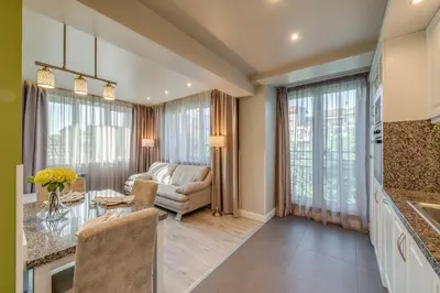 a kitchen and living room with a table and a couch at R & R Apartments in Sofia