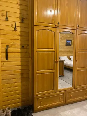 a wooden cabinet with a mirror in a room at Luxury private studio in Paradiso Verde in Bansko