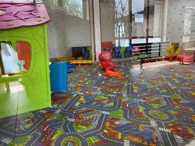 a play area with a colorful rug on the floor at Luxury private studio in Paradiso Verde in Bansko