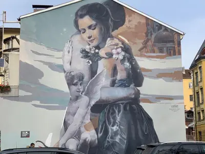 a large mural of a woman and a child on a building at Central and Spacious apartment in Sofia