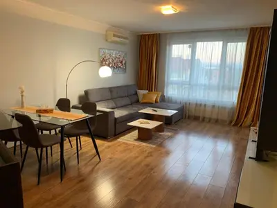 a living room with a couch and a table at Central and Spacious apartment in Sofia