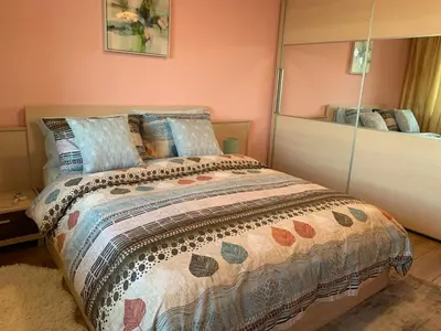 a bedroom with a bed and a mirror at Central and Spacious apartment in Sofia