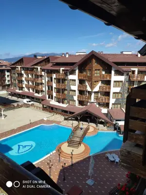 an aerial view of a hotel with a swimming pool at Bansko Belvedere Apartament in Bansko