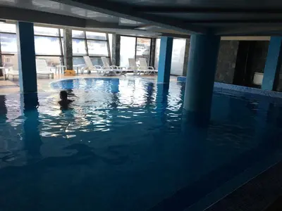 a person swimming in a swimming pool at Bansko Belvedere Apartament in Bansko