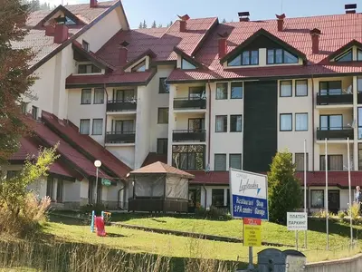 a large building with a sign in front of it at Снежанка in Pamporovo