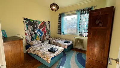 a small room with two beds and a window at Top Central Place with 2 bedrooms in Sofia in Sofia