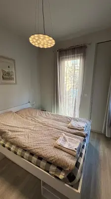 a bedroom with a large bed with a window at Top Central Place with 2 bedrooms in Sofia in Sofia