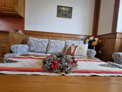 a bed with a christmas wreath on top of it at Pirin Golf Hotel Private Studios in Razlog