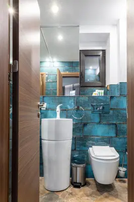 a bathroom with a toilet and a mirror at HIDDEN BANK: Digger's Dream in Plovdiv
