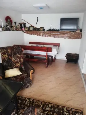 a living room with a couch and a tv at Стаи за гости РИЛА in Rila
