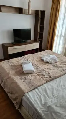 a bedroom with a bed with two towels on it at Luxury Apartment in Belvedere Club Hotel in Bansko