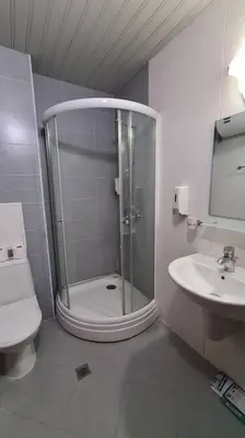 a bathroom with a shower and a toilet and a sink at Luxury Apartment in Belvedere Club Hotel in Bansko