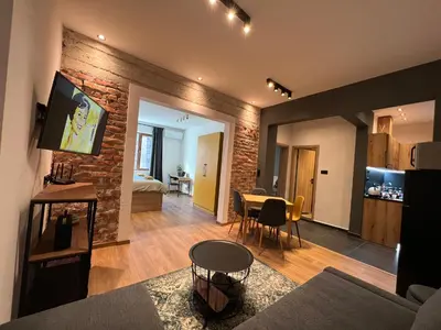 a living room and dining room with a brick wall at HOME 12 in Sofia