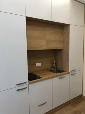 a kitchen with white cabinets and a sink at APARTHOTEL BON BON in Sofia