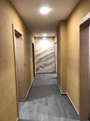 an empty hallway with a painting on the wall at APARTHOTEL BON BON in Sofia