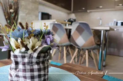 a vase of flowers sitting on a table in a kitchen at Victoria apartments 1 in Velingrad
