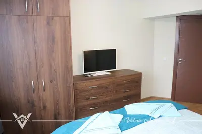 a bedroom with a bed and a television on a dresser at Victoria apartments 1 in Velingrad