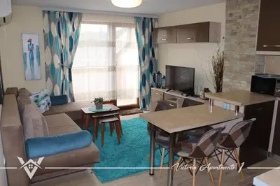 a living room with a couch and a table at Victoria apartments 1 in Velingrad