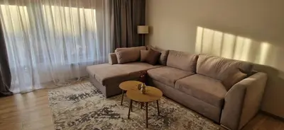 a living room with a couch and a table at Free SPA Pirin lodge cosy apartment in Bansko
