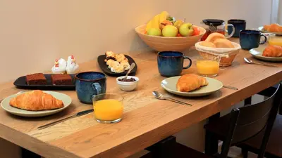 a table topped with plates of food and fruit at KOKICHE 4 Friends, Borovets in Borovets