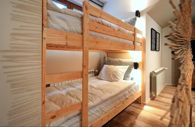 a bunk bed in a room with a wooden bunk bed at KOKICHE 4 Friends, Borovets in Borovets