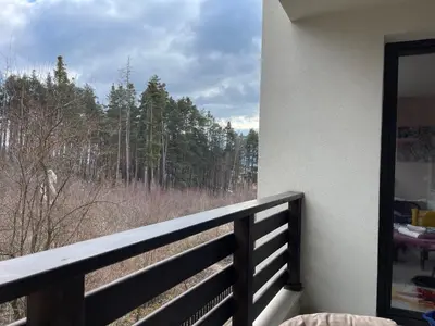 a balcony with a view of a forest at Nikol 2 Deluxe in Velingrad