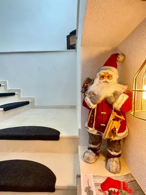 a santa claus figurine sitting on the side of a staircase at Kassandrov Guest House Ravnogor/ Касандрова къща Равногор in Yasă-Koriya