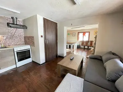 a living room with a couch and a table at Kassandrov Guest House Ravnogor/ Касандрова къща Равногор in Yasă-Koriya