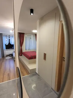 a room with a bedroom with a bed and a mirror at Pinewood ANG luxurious apartment A43, Borovets Gardens in Borovets