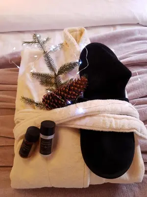 a towel with two bottles of essential oils on a bed at Pinewood ANG luxurious apartment A43, Borovets Gardens in Borovets