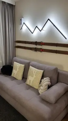 a living room with a couch with pillows at Pinewood ANG luxurious apartment A43, Borovets Gardens in Borovets