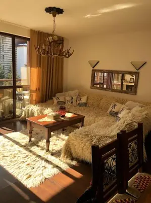 a living room with a couch and a coffee table at BREATHTAKING Mountain view 3 bedrooms appartement in Bansko