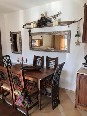 a dining room with a wooden table and a mirror at BREATHTAKING Mountain view 3 bedrooms appartement in Bansko